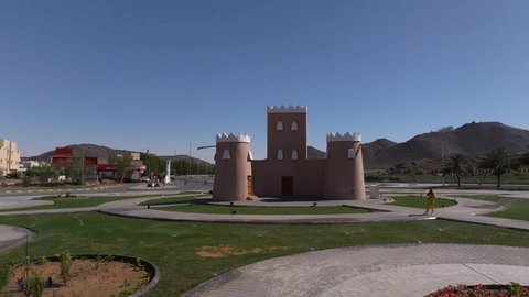 Traffic movement on the roads and streets of the Kingdom of Saudi Arabia, aerial drone photography of the castle roundabout in Hail, famous tourist attractions, trees and green plants surrounding Saudi regions and cities