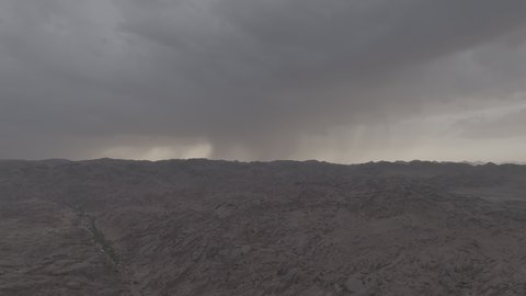 Rainfall over mountains and rock formations in the desert regions of Saudi Arabia, an ancient historical archaeological site, terrain, peaks and mountain heights in the desert, winter in the city of Hail