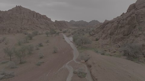 An ancient historical archaeological site, the terrain, peaks and mountain heights in the desert, a drone shot of the Aja Mountains in the city of Hail, mountains and rock formations in the desert regions of the Kingdom of Saudi Arabia