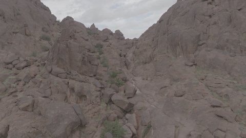 An ancient historical archaeological site, the terrain, peaks and mountain heights in the desert, a drone shot of the Aja Mountains in the city of Hail, mountains and rock formations in the desert regions of the Kingdom of Saudi Arabia