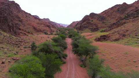An ancient historical archaeological site, the terrain, peaks and mountain heights in the desert, a drone shot of the Aja Mountains in the city of Hail, mountains and rock formations in the desert regions of the Kingdom of Saudi Arabia