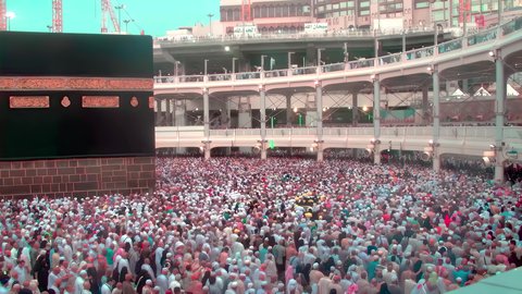 Visiting the Holy House of God in Mecca, performing the Hajj and Umrah rituals, the concept of worship and drawing closer to God Almighty, attracting and attracting Muslims from all over the world, pilgrims and Umrah performers circumambulating the Holy Kaaba in the Holy Mosque of Mecca