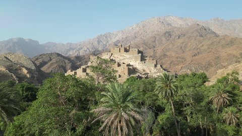 The Arabic architectural art of the old stone houses in Al Baha city, the mountain peaks and heights in the village of Dhi Ain, green trees and plants, a village on a white marble mountain, ancient historical monuments, tourist attractions in Saudi Arabia