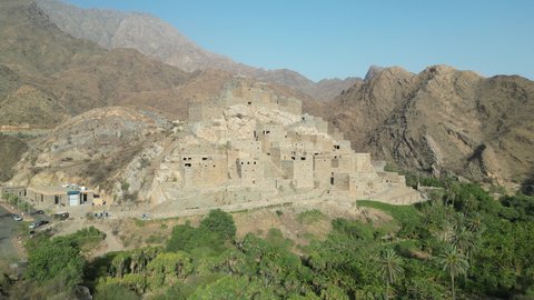 Ancient historical monuments, the Arabic architectural art of the old stone houses in Al Baha city, the mountain peaks and heights in the village of Dhi Ain, green trees and plants, a village on a mountain of white marble, tourist attractions in Saudi Arabia