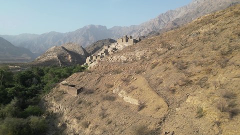 Ancient historical monuments, the Arabic architectural art of the old stone houses in Al Baha city, the mountain peaks and heights in the village of Dhi Ain, green trees and plants, a village on a mountain of white marble, tourist attractions in Saudi Arabia