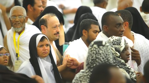 Pilgrims stand on Mount Arafat in the Kingdom of Saudi Arabia, praying and turning to God Almighty on the Mount of Mercy, humility and great Islamic feelings of faith, performing the duties of Islam in Mecca, completing the Hajj rituals