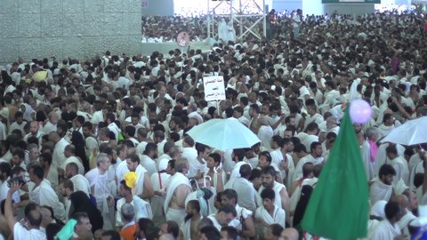 The concept of worship and drawing closer to God, pilgrims throwing stones at the Jamarat in Mecca, performing Hajj rituals, a destination for Muslims from all over the world, a sacred Islamic religious place and landmark in the Kingdom of Saudi Arabia