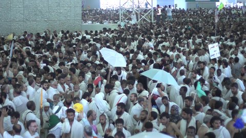 The concept of worship and drawing closer to God, pilgrims throwing stones at the Jamarat in Mecca, performing Hajj rituals, a destination for Muslims from all over the world, a sacred Islamic religious place and landmark in the Kingdom of Saudi Arabia