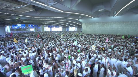 Pilgrims perform the stoning of the Jamarat in Mecca, performing the Hajj rituals, a destination for Muslims from all over the world, a sacred Islamic religious place and landmark in the Kingdom of Saudi Arabia, the concept of worship and drawing closer to God