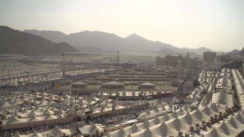 Spending the night in the Sacred Sites during the day, a sacred Islamic religious site in the Kingdom of Saudi Arabia, the pilgrims’ march to the tents in Mina in the city of Mecca, completing the Hajj rituals