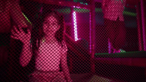 Emirati girl receiving a greeting with happy expressions, fun sports activities, photography of an Arab Gulf Emirati child wearing casual wear, crawling inside play corridors, overcoming rubber obstacles, exploring challenging paths, indoor play center, having a good time