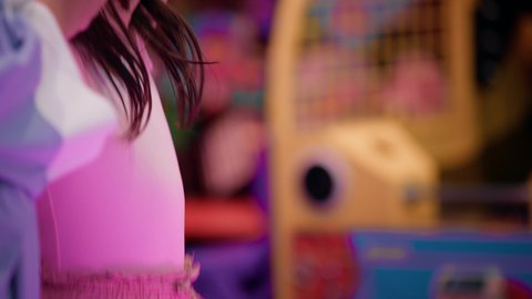 مراكز الالعاب الترفيهيه في الامارات، قضاء اوقات ممتعه ، أجواء مليئة بالمرح والحماس، تصوير لطفلة عربية خليجية إماراتية ترتدي الزى الكاجوال ، تستمتع بلعب الهوكي الهوائي ، طاولة مضيئة بألوان زاهية