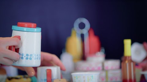 Girls ’passion for kitchen and cooking, future jobs and professions, support and development of children's cooking skills, enjoy playing at the Entertainment Games Center, photograph close to the hands of an Arab Gulf Arab woman who plays kitchen tools with her child