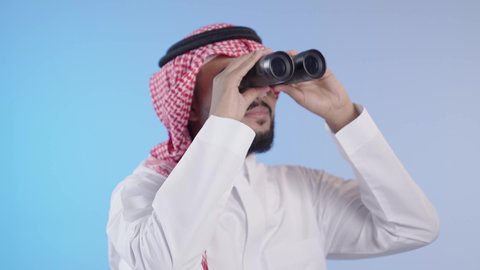 رؤية الاشياء البعيدة عبر التلسكوب, حب المغامرة والاستكشاف، التخطيط المستقبلي للأهداف والطموحات، شاب عربي خليجي سعودي يرتدي الثوب التقليدي والشماغ ينظر من خلال المنظار ثنائي العينين
