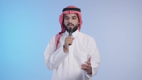 Presenting and discussing ideas, exchanging dialogues and effective communication. A Saudi Arabian Gulf man wearing the traditional thobe and shemagh holding a loudspeaker, giving speeches, conducting interviews and asking questions.
