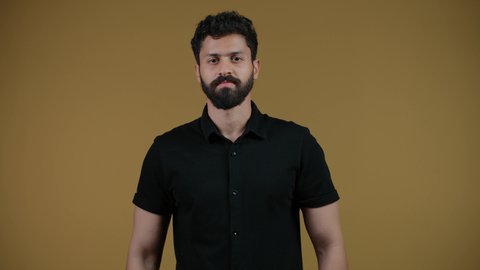 Communicating with family and friends, looking at the camera with cheerful gestures, following the latest news and developments around the world, integrating modern technologies into practical life, a photograph of a young Arab Gulf Emirati man wearing casual clothes making a phone call, yellow background