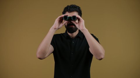 The concept of exploration and adventure, searching for something and expanding the field of vision using binoculars, future visions of young people, a picture of a young Arab Gulf Emirati man wearing casual clothes jumping high and looking through binoculars, yellow background