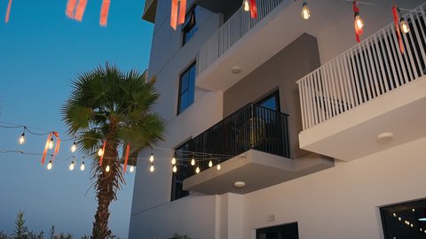 Documenting happy family moments, having fun, using modern technology, an Emirati Gulf Arab woman wearing a black abaya sitting inside a cafe with her husband taking a selfie with her mobile phone, gestures of happiness and pleasure