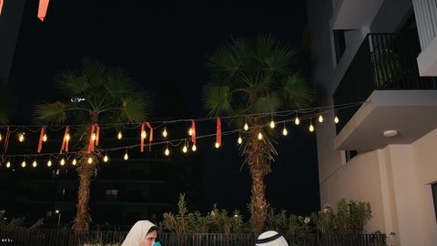 Fun, acquaintance and a happy atmosphere in an Emirati café, Arab Gulf Emirati friends enjoying exchanging conversation, cold drinks and delicious food, an Emirati diwaniya, discussions, dialogues and spending a pleasant time, fun, acquaintance and a happy atmosphere