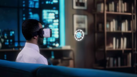 اختيار الملابس والتسوق بالتقنية والتكنولوجيا المستقبلية الحديثة, رجل عربي سعودي خليجي يرتدي الثوب التقليدي ونظارات ثري دي يجلس في منزله يقوم بالتفاعل مع عناصر هولوجرامية ثلاثية الأبعاد، رؤية مستقبيلة سعودية 2030