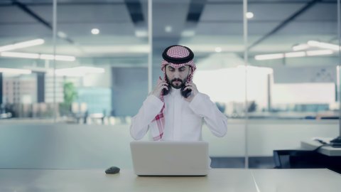 Working in technology companies and modern technology, a Saudi Arabian Gulf man wearing a shemagh, thobe and headphones using a laptop, 3D holographic elements background, the development of the work system with technology and modern technology