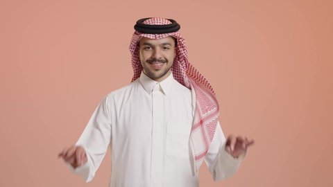 رفع اليد بعلامات الجودة والقبول، الامتياز والعلامة الكاملة، الشعور بالرضا والاستحسان، بورتريه لرجل عربي خليجي سعودي مبتسم يرتدي الثوب التقليدي والشماغ ينظر إلى الكاميرا بإيماءات السعادة والسرور