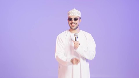 Musical theatrical art, singing with enthusiasm and a loud voice, presenting theatrical performances, a portrait of a young Arab Gulf Omani man wearing a dishdasha, kumma, and sunglasses practicing the hobby of singing for fun and entertainment holding a microphone in his hand, artistic talents in the world of music, gestures and expressions of integration and happiness, purple background.