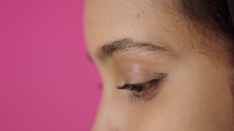 صالون تجميلي نسائي، ادوات مكياج تتوريال، بورترية مقرب من الجانب لامراة عربية خليجية سعودية سمراء تحمل (قلم المسكرة) لإبراز العين، التسويق لمنتجات التجميل، متجر بيع مستحضرات التجميل عبر الإنترنت، مفهوم الإهتمام بالجمال والبشرة