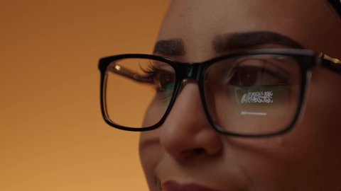 The reflection of the Saudi flag in the lens of the eye, a close-up shot of the eye of a smiling Arab Gulf girl from Saudi Arabia wearing glasses, looking proudly at the flag of the Kingdom, commemorating Saudi National Day on September 23, the day of the establishment of the first Saudi state in 1727 AD.