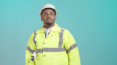 Monitoring architectural projects, working in the field of structural engineering, supervising the progress of construction work, a portrait of a Saudi Gulf Arab engineer wearing a vest and safety helmet holding the engineering plan, overseeing the execution at the work site, pointing to something, green background.