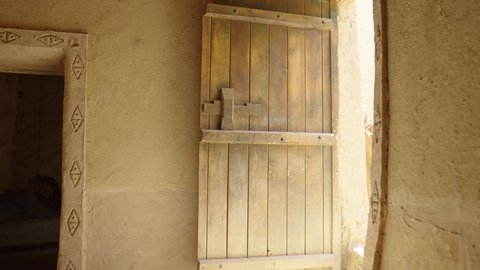 Monitoring and guarding to defend and preserve the history and heritage of the Kingdom, the day we began, February 22, war and fighting with guns to protect the homeland, the establishment of the first Saudi state in 1727 AD, a Saudi Gulf Arab man wearing traditional folk costume carrying a gun in a mud-brick neighborhood