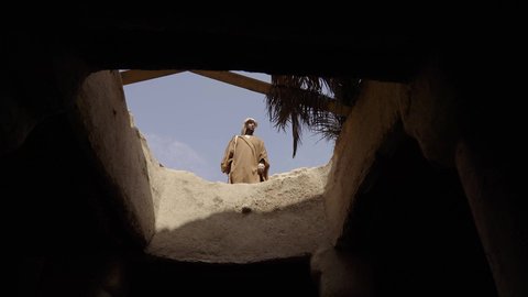 Guarding and monitoring to defend and preserve the history and heritage of the Kingdom, the day we began, February 22, war and fighting with guns to protect the homeland, the establishment of the first Saudi state in 1727 AD, a Saudi Gulf Arab man wearing traditional folk costume carrying a gun in a mud-brick neighborhood