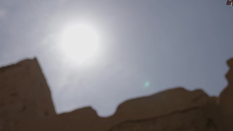 Ancient war tools, sword fighting for protection and the establishment of the first Saudi state in 1727 AD, two Saudi Gulf Arab men wearing traditional costumes dueling with swords in a mud house, the day of our beginning, February 22, the concept of war and defending the homeland, preserving the history and heritage of the Kingdom