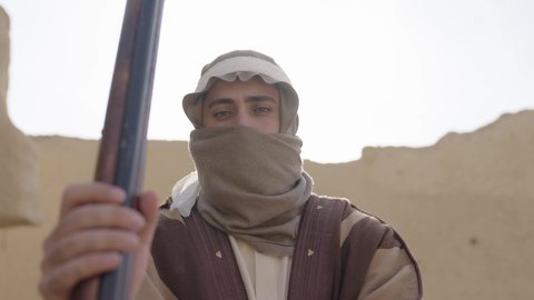 Preparing and equipping to defend and protect the homeland, using weapons to preserve the kingdom's property, a Saudi Arabian Gulf man wearing traditional folk costume holding a rifle in his hand, the day of our beginnings 1727 AD, the anniversary of the founding of the first Saudi state, February 22