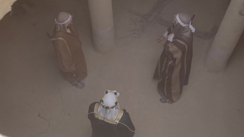 Guarding and monitoring to defend the homeland, dialogue and planning for war, the day we began, February 22, fighting with rifles to protect and establish the first Saudi state in 1727 AD, a group of masked Saudi Gulf Arab men wearing traditional folk costumes carrying rifles