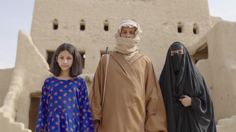 The anniversary of the founding of the first Saudi state, February 22, a Saudi Arabian Gulf family wearing traditional folk costumes on national holidays and occasions, standing in one of the heritage houses built of mud, expressions and gestures of pride, honor and happiness, the day we began 1727 AD