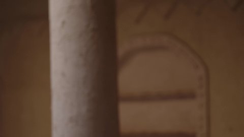 The day we started, February 22nd, a Saudi Arabian Gulf man wearing a bisht, ghutra, and a wide golden agal standing in an old mud house, the concept of patriotism and belonging to the homeland, an old historical village, wearing traditional folk costume on a national holiday and occasion, commemorating the founding of the first Saudi state in 1727 AD