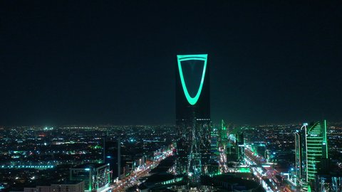 The economic and cultural renaissance in the Kingdom of Saudi Arabia, urban development and growth in cities and neighborhoods, aerial photography of roads and streets in, the Kingdom Tower in Riyadh at night, towers and skyscrapers built in a modern style, a famous tourist attraction in the capital