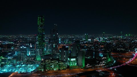 King Abdullah Financial District (KAFD), economic and urban renaissance, aerial drone footage of Riyadh's skyline at night, modern and sophisticated towers and skyscrapers, famous commercial and economic landmarks