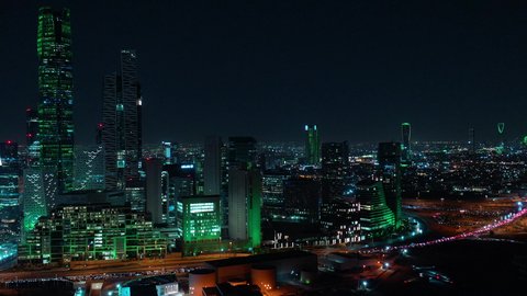 King Abdullah Financial District (KAFD), economic and urban renaissance, aerial drone footage of Riyadh's skyline at night, modern and sophisticated towers and skyscrapers, famous commercial and economic landmarks