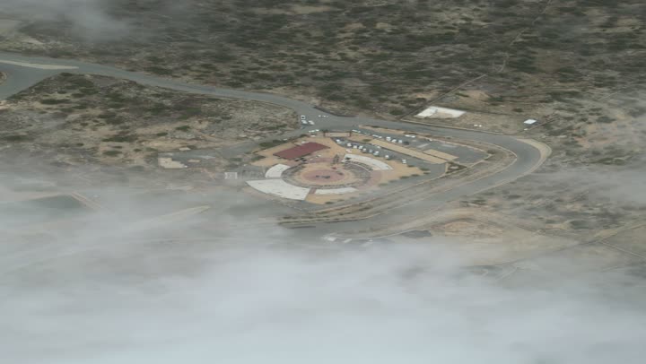 The rocky mountain ranges of Abha and Namas, the rugged, stony terrain, aerial photography of the mountainous environment in the Asir region, attracting tourists from all over the world, famous natural tourist sites and landmarks, trees and plants on the mountain slopes
