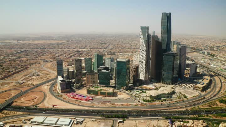 Famous landmarks of commerce and economy, King Abdullah Financial District (KAFD), economic and urban renaissance, aerial drone photography of Riyadh's skyline during the day, modern and advanced towers and skyscrapers