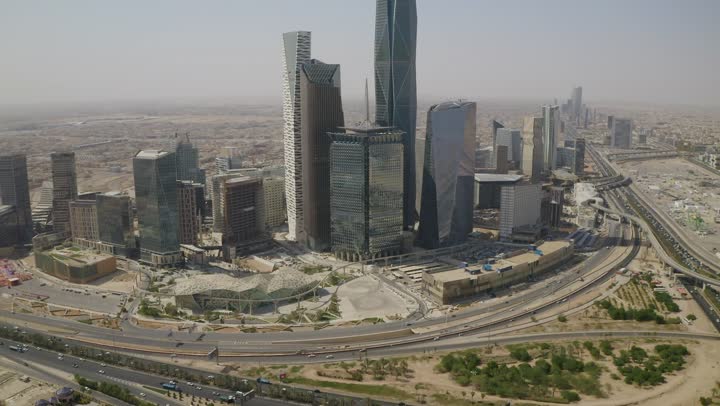 Famous landmarks of commerce and economy, King Abdullah Financial District (KAFD), economic and urban renaissance, aerial drone photography of Riyadh's skyline during the day, modern and advanced towers and skyscrapers
