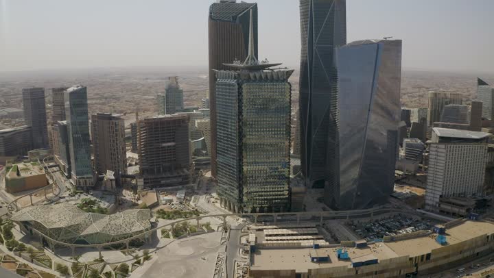 Famous landmarks of commerce and economy, King Abdullah Financial District (KAFD), economic and urban renaissance, aerial drone photography of Riyadh's skyline during the day, modern and advanced towers and skyscrapers