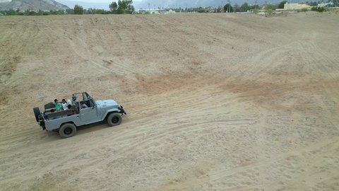 Safari trips in the deserts of the Kingdom of Saudi Arabia, spending a unique trip in the desert environment, driving an old white jeep in the Najran Valley, (dune-riding) in the middle of the desert, an exciting safari adventure on the sand dunes and hills, a fun recreational activity