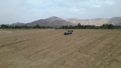 Safari trips in the deserts of the Kingdom of Saudi Arabia, spending a unique trip in the desert environment, driving an old white jeep in the Najran Valley, (dune-riding) in the middle of the desert, an exciting safari adventure on the sand dunes and hills, a fun recreational activity