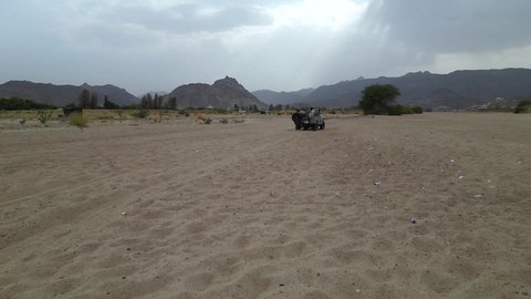 A fun recreational activity, safari trips in the deserts of the Kingdom of Saudi Arabia, spending a special trip in the desert environment, driving an old white jeep in the Najran Valley, (dune bashing) in the middle of the desert, an exciting safari adventure on the sand dunes and hills.