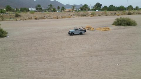 A fun recreational activity, safari trips in the deserts of the Kingdom of Saudi Arabia, spending a special trip in the desert environment, driving an old white jeep in the Najran Valley, (dune bashing) in the middle of the desert, an exciting safari adventure on the sand dunes and hills.