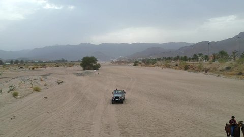 The hobby of riding purebred Arabian horses, an exciting safari adventure on the sand dunes and hills, a fun recreational activity, safari trips in the deserts of the Kingdom of Saudi Arabia, spending a special trip in the desert environment, driving an old white jeep in the Najran Valley, (drifting) in the middle of the desert