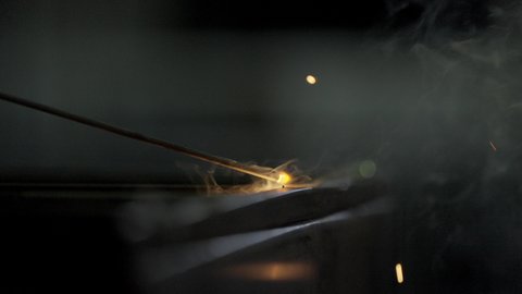 Preparing and connecting iron with welding equipment and tools, Saudi professions and jobs, skill in mastering work in a blacksmith factory, close-up of metal welding, sparks flying in 